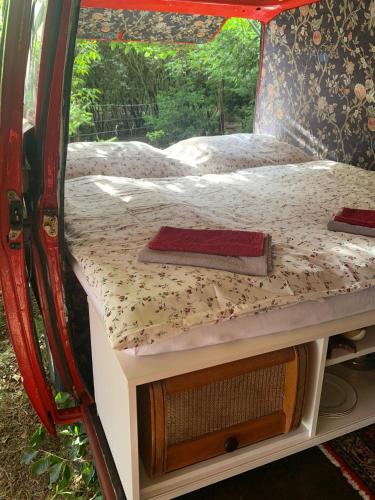 a bed in the back of a camper with two beds at Nad rybníkem Hnačov - rodinný rekreační areál in Hnačov