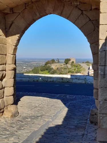 an archway in a building with a view of the ocean at Monte do Ribeiro Baço - Monsaraz in Monsaraz