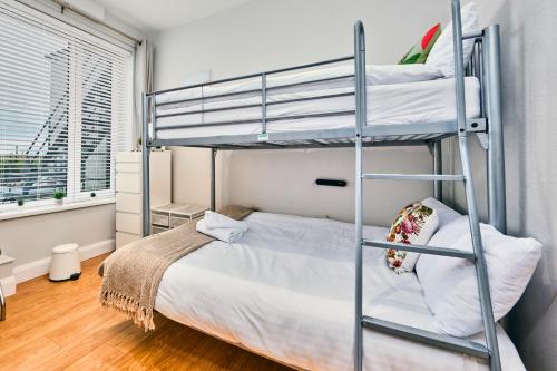 a bedroom with two bunk beds and a bed at West Beach 3 - Portrush by the Sea in Portrush