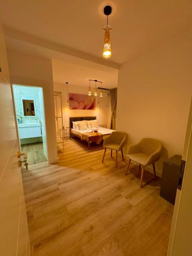 a room with a bed and a table and chairs at Villa NIAN Boutique in Constanţa