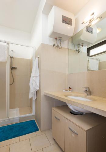 a bathroom with a sink and a shower at Kamena Residence in Marina di Ragusa