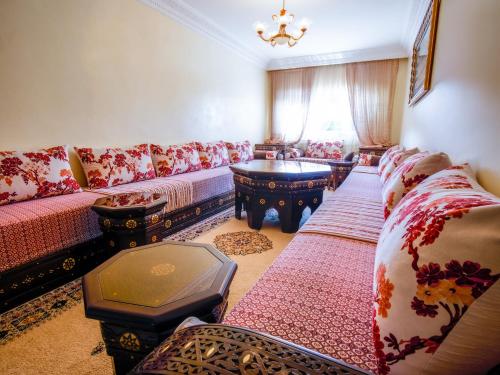 a living room with a couch and a table at Cozy family appartement in Tangier