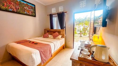 Postel nebo postele na pokoji v ubytování Adhi Homestay