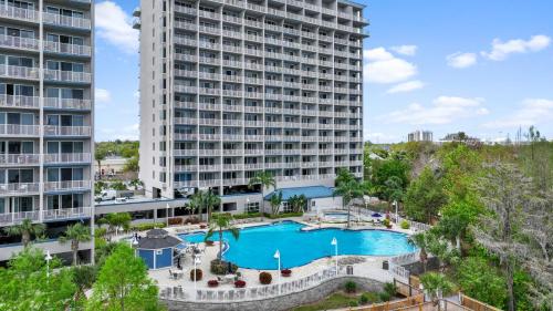 an aerial view of a large apartment building with a pool at 5-Min to Disney Lakeside Retreat in Orlando