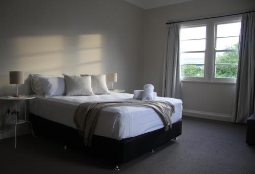 a bedroom with a large bed with a window at Victoria Street Apartments in Grafton