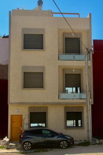 a black car parked in front of a building at Atlantic coast imssouane in Imsouane