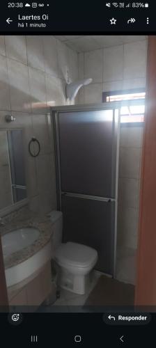 a bathroom with a toilet and a sink at Casa Lagoa e Praia Rosa in Praia do Rosa