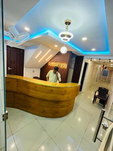a man standing at a bar in a restaurant at Priya lodge in Kozhikode