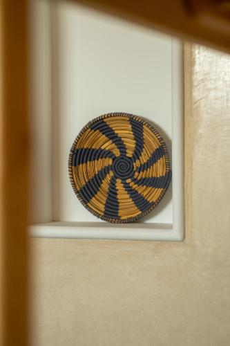 a yellow and black hat sitting on a window sill at tayyurt host in Agadir