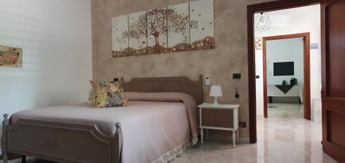 a bedroom with a bed and a table and a mirror at La casa dei nonni in San Salvo