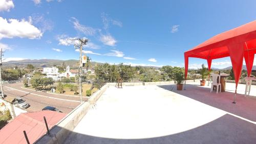a skateboard ramp on top of a building with a red roof at Hotel Suite Central Park Tababela in Quito
