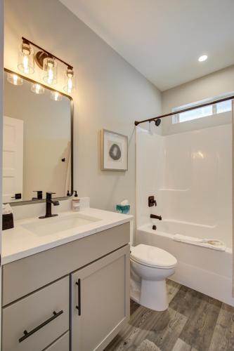 a bathroom with a sink and a toilet and a shower at Fancy Finish Cottage in Ocean Shores