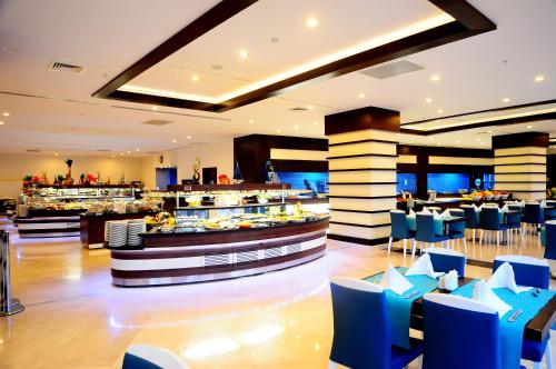 un ristorante con sedie blu e un bar di Side Prenses Resort Hotel & Spa a Side