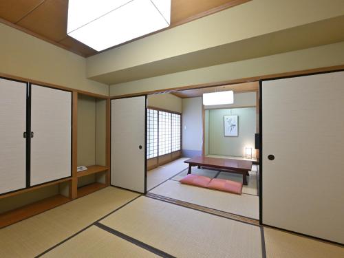 a room with sliding doors and a room with a table at Rihga Hotel Zest Takamatsu in Takamatsu
