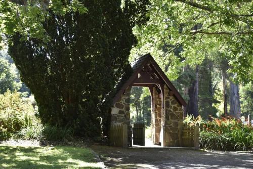 a small stone dog house in a park at Romantic Retreat in the Dandenong Mountains in Kalorama