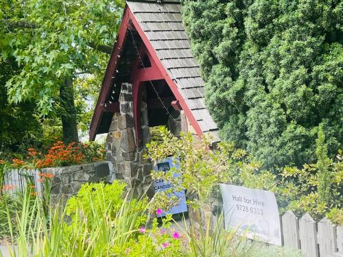 a small house in the middle of a garden at Romantic Retreat in the Dandenong Mountains in Kalorama