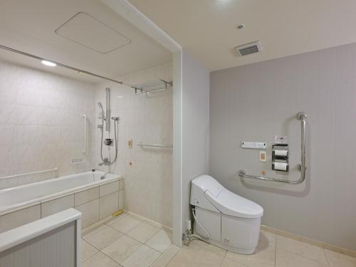 a bathroom with a tub and a toilet and a sink at Rihga Hotel Zest Takamatsu in Takamatsu