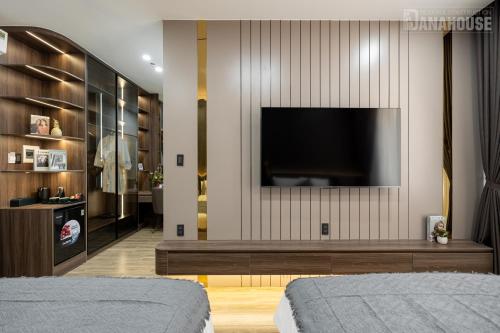 a living room with a flat screen tv on a wall at Khách sạn Trung Trầm in Dong Hoi