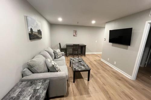 a living room with a couch and a table at Aksarben Apt-Cozy One Bedroom in Omaha