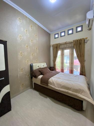 a bedroom with a bed and a window at Merapi View Homestay in Ngaglik