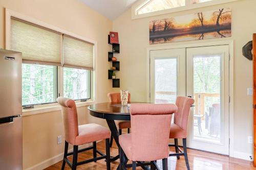 a kitchen with a table and chairs and windows at Poplar Treehouse - Rustic Luxury in Marshall