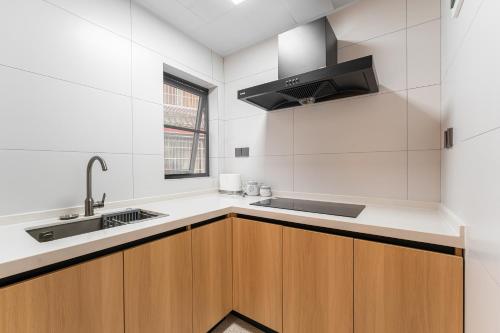 a kitchen with wooden cabinets and a sink at Miss Autumn House in Yangshuo