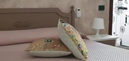 a bedroom with a bed with two pillows on it at La casa dei nonni in San Salvo