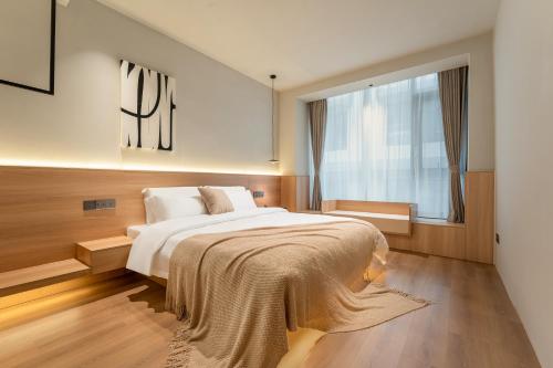 a bedroom with a large bed and a window at Miss Autumn House in Yangshuo