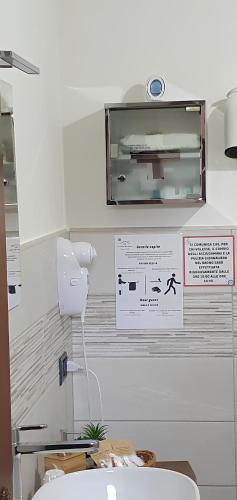 a bathroom with a sink and a sign on the wall at La casa dei nonni in San Salvo
