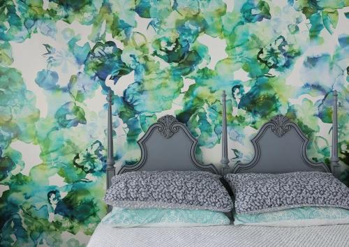 a bedroom with a bed with a blue and green wall at Buderim Rainforest Retreat - 10 mins to Mooloolaba in Buderim