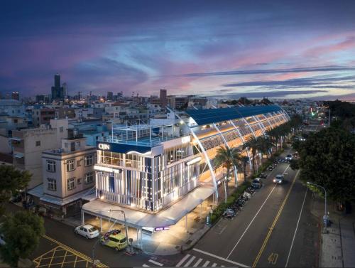 a large white building on a city street at night at In Young Hotel in Kaohsiung