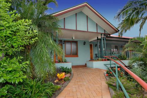 a house with a brick walkway in front of it at Puffers Inn in Loganholme
