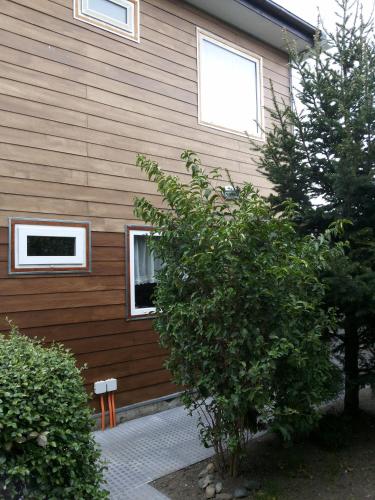 a house with two windows on the side of it at VALYAK rent apart hotel - Servicios Integrales in Punta Arenas