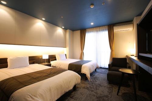 Ένα ή περισσότερα κρεβάτια σε δωμάτιο στο Kirishima Kanko Hotel