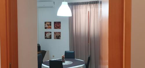 a room with a white table and a white curtain at La casa dei nonni in San Salvo