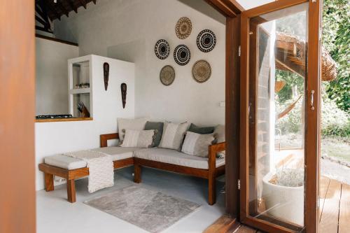 a living room with a couch and a window at Aore Paradise - Near Santo, Vanuatu in Aore Island