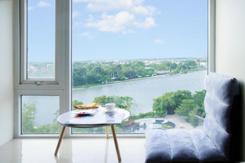 a living room with a table and a large window at Sai Gon Dong Ha Hotel - a member of Saigontourist Group in Quảng Trị