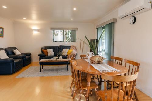a living room with a table and a couch at Prime location at Mt Eden- Cozy Vibe 3BR Home in Auckland