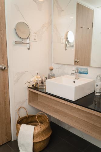 a bathroom with a sink and a mirror at Macau Hotel S - Formerly - Macau Hotel Sun Sun in Macau
