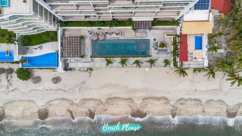 an overhead view of a beach with a swimming pool at Casa del Mar Bucerias - Beachfront Condos in Bucerías