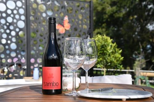 a bottle of wine and two wine glasses on a table at Counting Stars in Yarragon