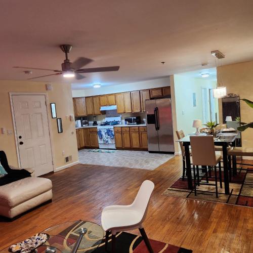 a living room and kitchen with a table and chairs at Modern Comfort in Newark