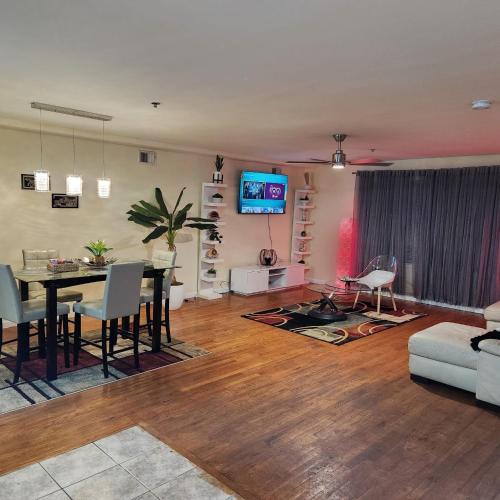 a living room with a dining table and a tv at Modern Comfort in Newark