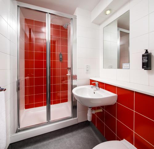 a bathroom with a shower and a sink at Go2 Portishead Marina Hotel in Portishead