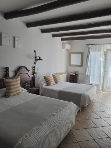 Кровать или кровати в номере Hotel El Balcon de las nieves