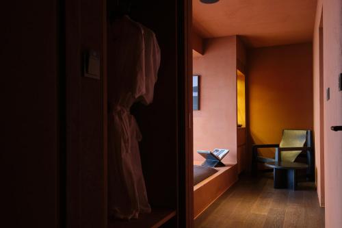 a hallway with a room with a table and a chair at After Chapter Hotel Gwanganri in Busan