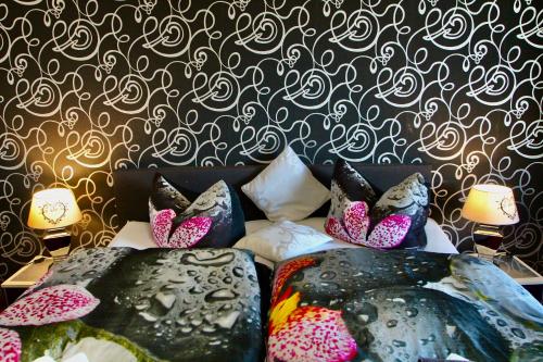 a bed with three pairs of shoes on it at Suite-Apartment-Essen in Essen