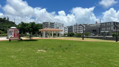 a park with a red phone booth and buildings at Kokoro no yado Mihama in Chatan