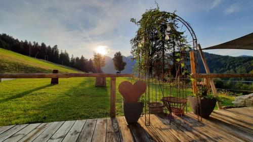 a wooden deck with a bench and a table and a swing at Ferienwohnung Hochfelln in Ruhpolding