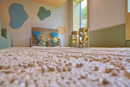 a room with a bed with lots of legos on the floor at Hotel Royal Chiao Hsi in Jiaoxi